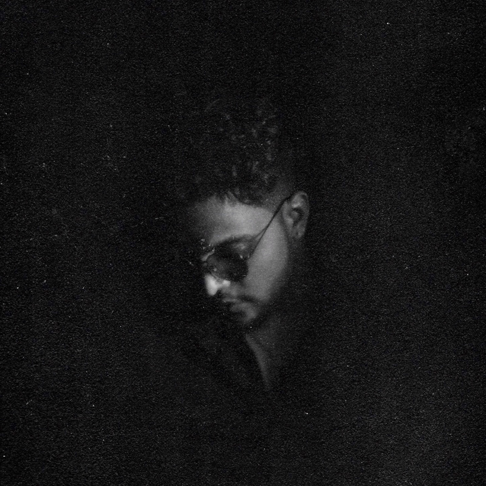 Grainy black-and-white portrait of AYSH in profile